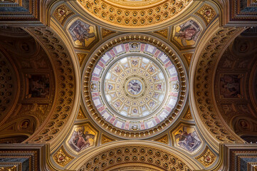 Budapest, Hungary - Feb 8, 2020: Luxarily decorated golden ceiling with cupola in St. Stephen's Basilica