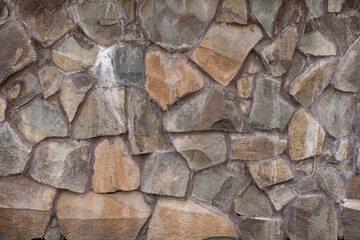 The texture of rough stone. Masonry from large boulders. Foundation. Building background.