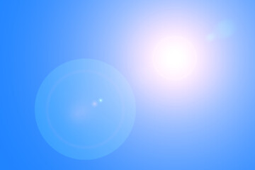 Lens flares from the sun on blue clear sky, nature background
