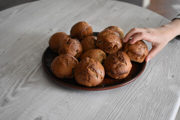 Hand taking the cupcake.