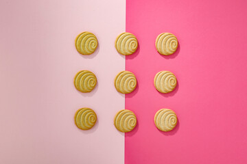 Aerial butter cookies on a pink background