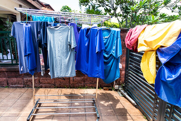 Laundry fabric being dried under bright hot sun in home compound after wash