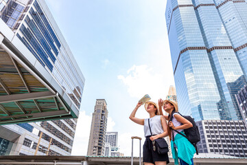 Asian tourists are traveling in big cities with tall buildings. Bangkok, Thailand.