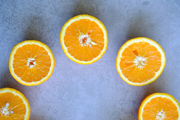 Orange Slices, half cut oranges on a marble background