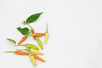 Green and red chilies with white background. Chillies, ingridient of Thai or asian food.