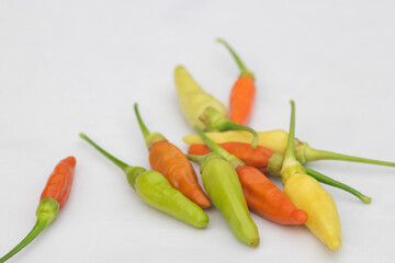Green and red chilies with white background. Chillies, ingridient of Thai or asian food.