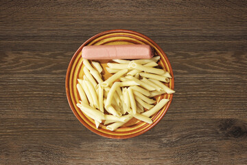 Pasta and sausage in a plate. Fast and cheap breakfast. Homemade food. Fast food. Quarantined Meals