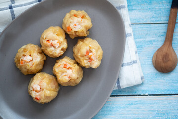 Group of hot steam shrimp dumpling served on gray dish