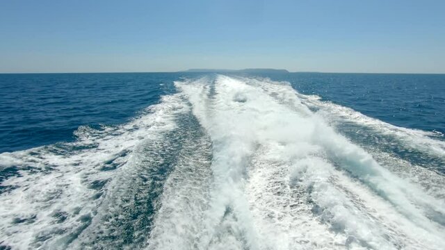 Outboard engine waves from powerful fast moving boat transportation ship from tropical island in Thailand 