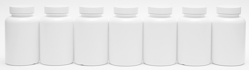 Banner with seven white plastic containers for pills isolated on white background