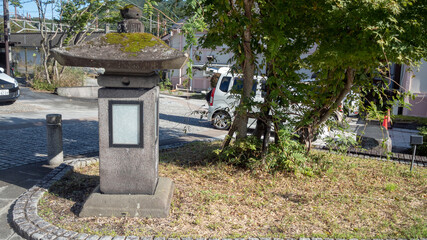 Japanese stone lantern at walk path in midtown for background with copy space