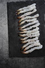 Raw Shrimp stretched out to prepare Tempura