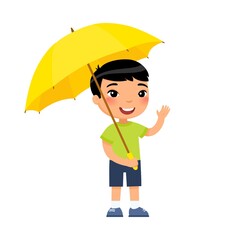 Little asian boy with yellow umbrella smiles and waves his hand. Male child standing cartoon character. Rainy weather concept. Summer or fall season. Flat vector illustration