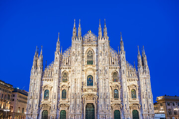 Sculptures and carvigs on the facade of the Cathedral of Milan at twilight in Milan, Lombardy, Italy