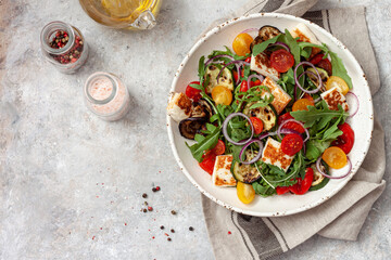 Fresh vegetable salad with arugula, grilled vegetables, sherry tomatoes and  halloumi cheese.Healthy food