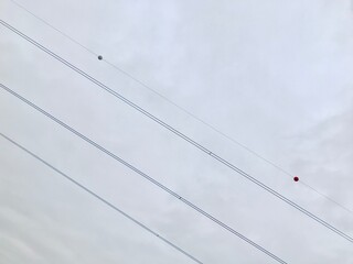 Power lines on cloudy background