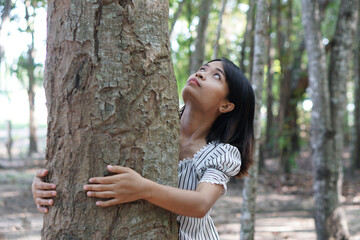 Asian women huging trees , the concept of love for the world     