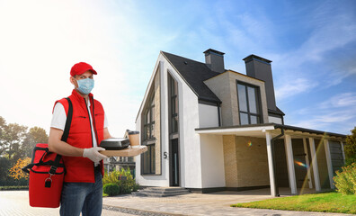 Courier in protective mask and gloves with order on street. Delivery service during coronavirus quarantine