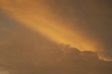 Beautiful vivid yellow sun cast over the cloud at sunset