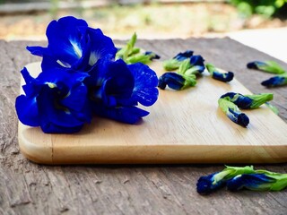 Butterfly Pea Flowers or Clitoria Ternatea On the wooden floor. Can be used in cooking or beverages