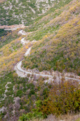 Curvy mountain empty road, Xanthi region, Northern Greece. High angle view, late autumn hazy day, travel photography