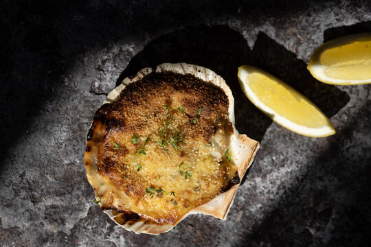 Coquille St Jacques scallop shellfish filled with white wine and cheese cream sauce, topped with breadcrumbs