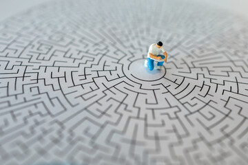 Miniature people : The man writting the book on center of maze : Concepts Troubleshooting Analysis...