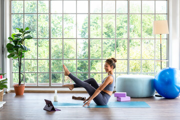 Yoga student learning online from internet watching course from streaming at home