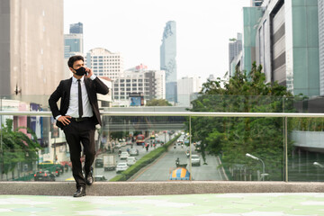 Businessman wearing suit and mask talking via smartphone make phone call