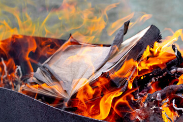 An open book is burning on the hearth