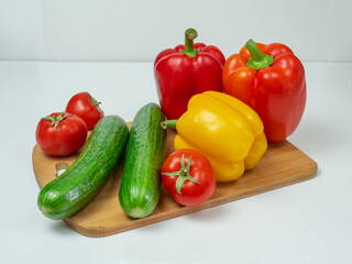 Delicious cuisine. Fresh vegetables on a wooden board, ready for slicing lettuce