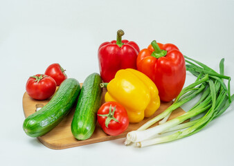 Delicious cuisine. Fresh vegetables on a wooden board, ready for slicing lettuce