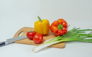 Delicious cuisine. Fresh vegetables on a wooden board, ready for slicing lettuce