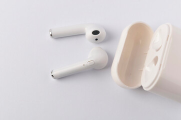 A white wireless headphone on white background.