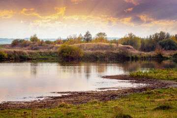Fototapeta na wymiar Sunset on the river. Picturesque autumn landscape