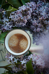 Fototapeta na wymiar cup with coffee and lilac