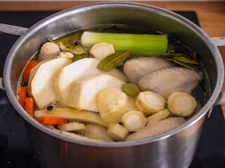 Broth - boiling chicken soup in pot
