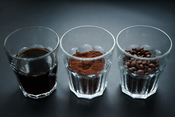 
three cups with coffee beans, ground coffee and coffee