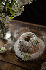 Rustic style apple bundt cake with powdered sugar on old wooden table