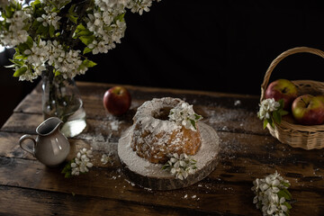 Obraz na płótnie Canvas Rustic style apple bundt cake with powdered sugar on old wooden table