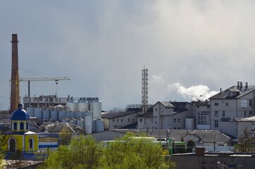 white smoke from a chimney against a cloudy sky	