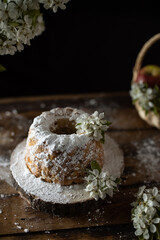 Rustic style apple bundt cake with powdered sugar on old wooden table