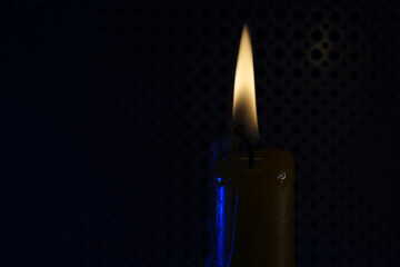 Candle with smoke and flame photographed in the studio with color foils before the flashes