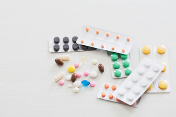 pills on white wooden table