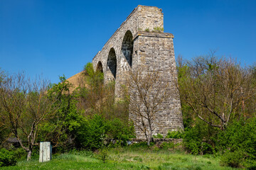 Old viaduct. Unfinished railway bridge made of stone.