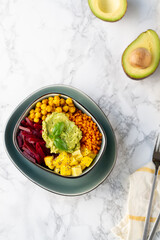 Healthy vegan lunch bowl. Avocado,lentil, mango,beet and chickpeas. Vegetables salad. Top view