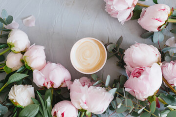 Coffee and flowers. Stylish composition of cappuccino and peonies.