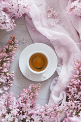 Obraz na płótnie Canvas Flowers and coffee. Lilac and coffee, a beautiful composition. Flat lay. Flower concept.