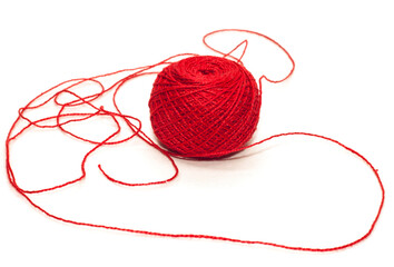 A ball of red yarn for crocheting or knitting on a white background. Isolated