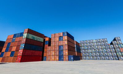 Fototapeta premium Lifting empty container to keep in container stack by reach stacker